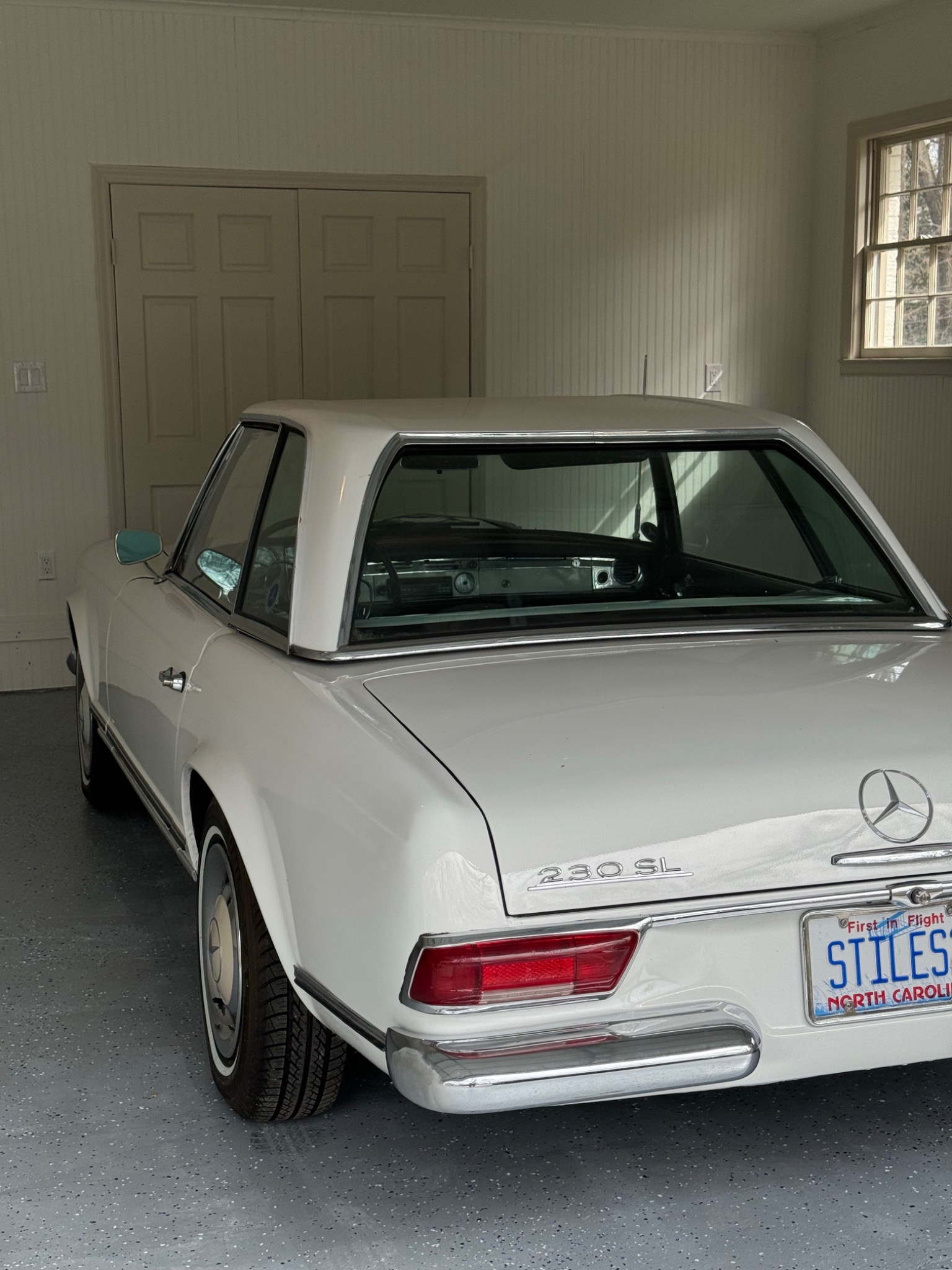 Vintage white Mercedes in a warm studio