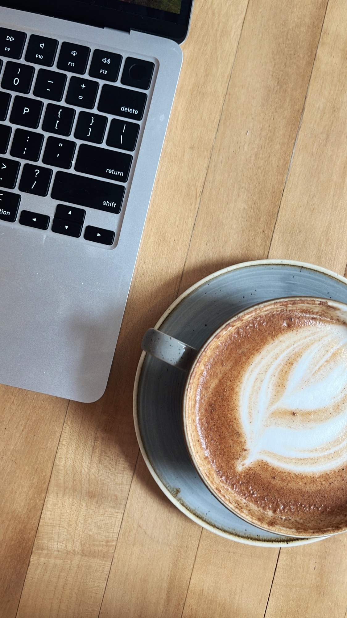 Latte beside a laptop