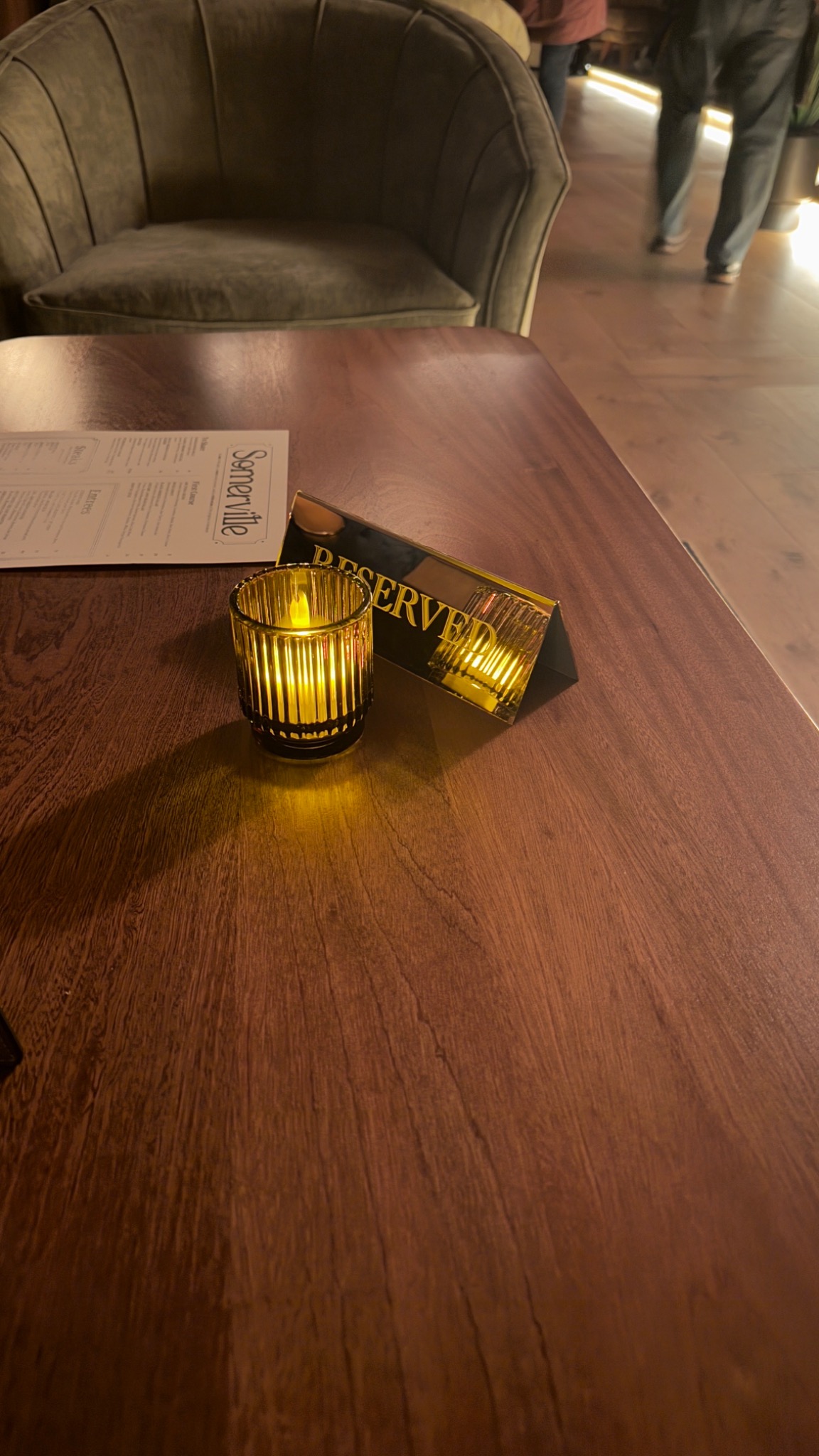 Reserved sign and candle on a gathering table