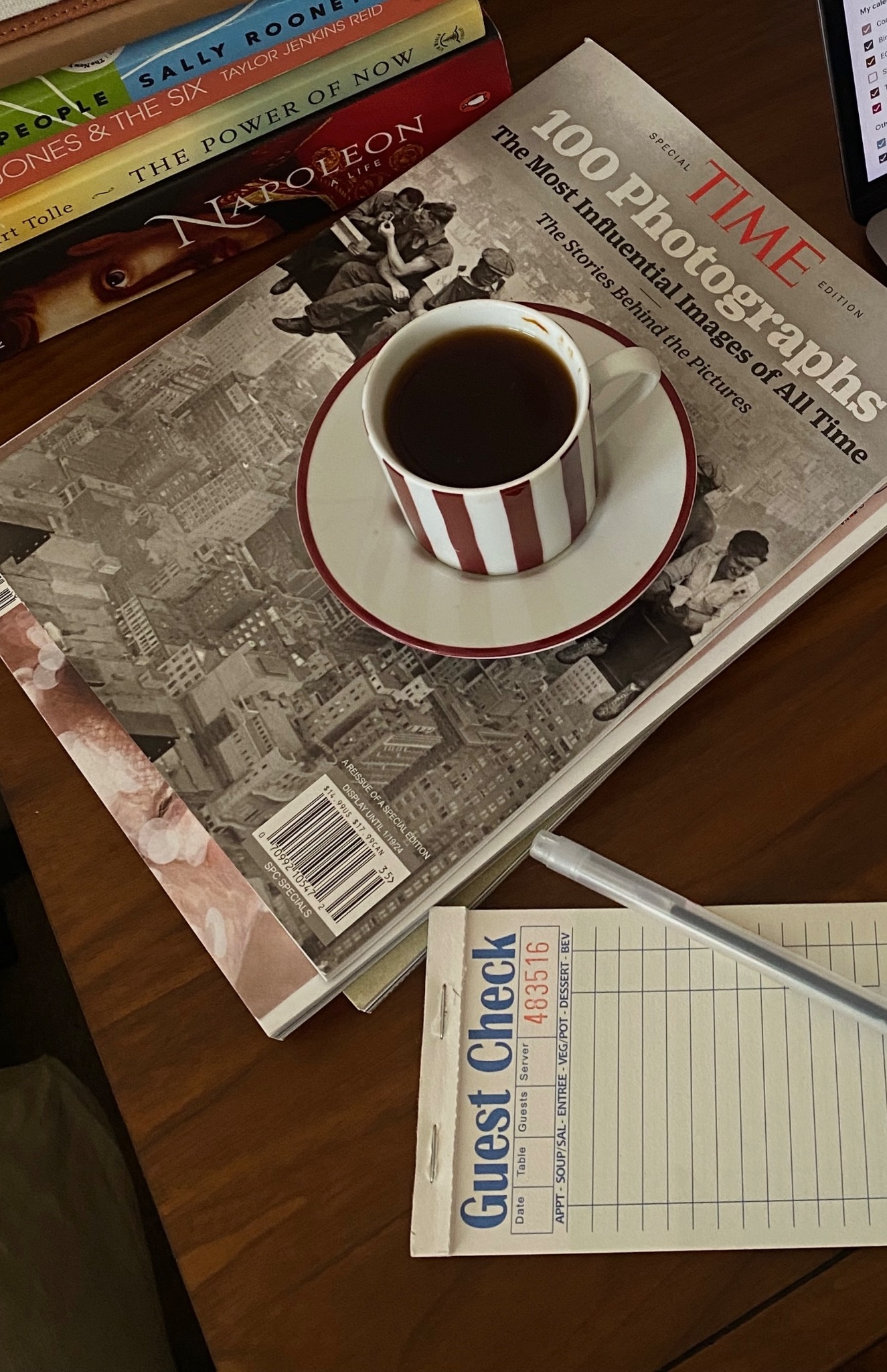 Coffee, books and a guest check on a work table