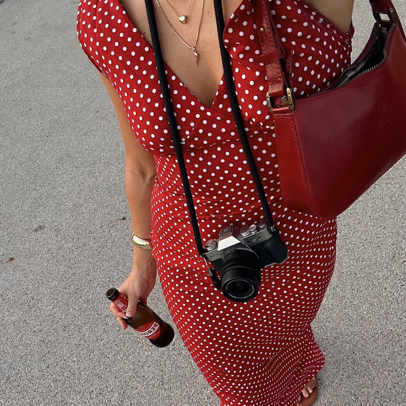 Creative carrying a camera and red portfolio