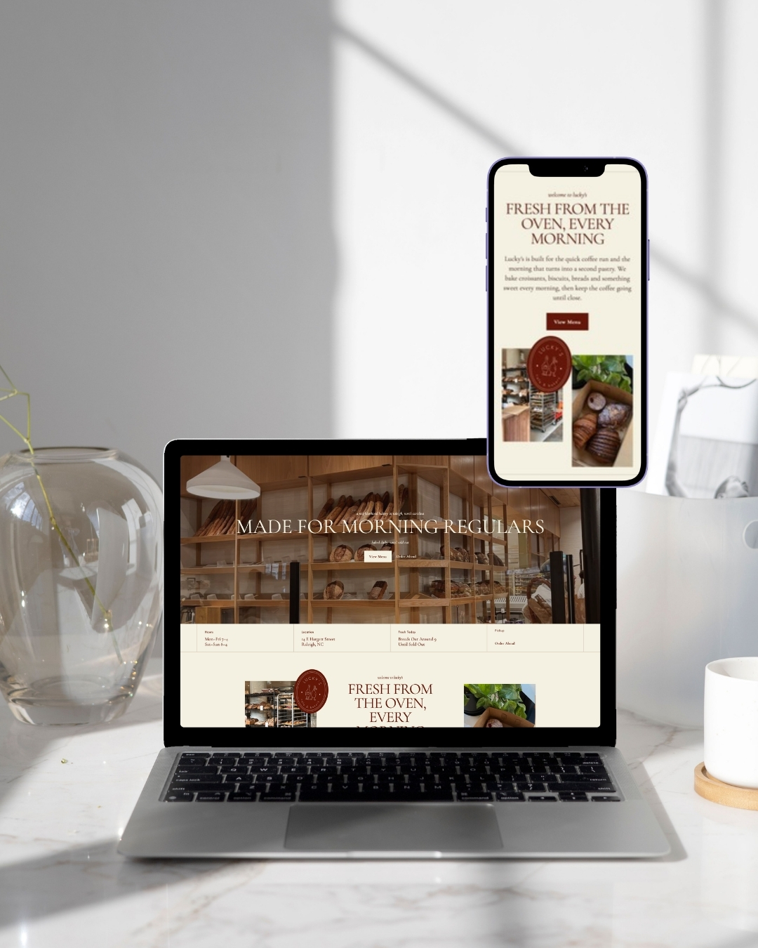 Laptop and phone mockups showing the Lucky’s Café & Bakery website